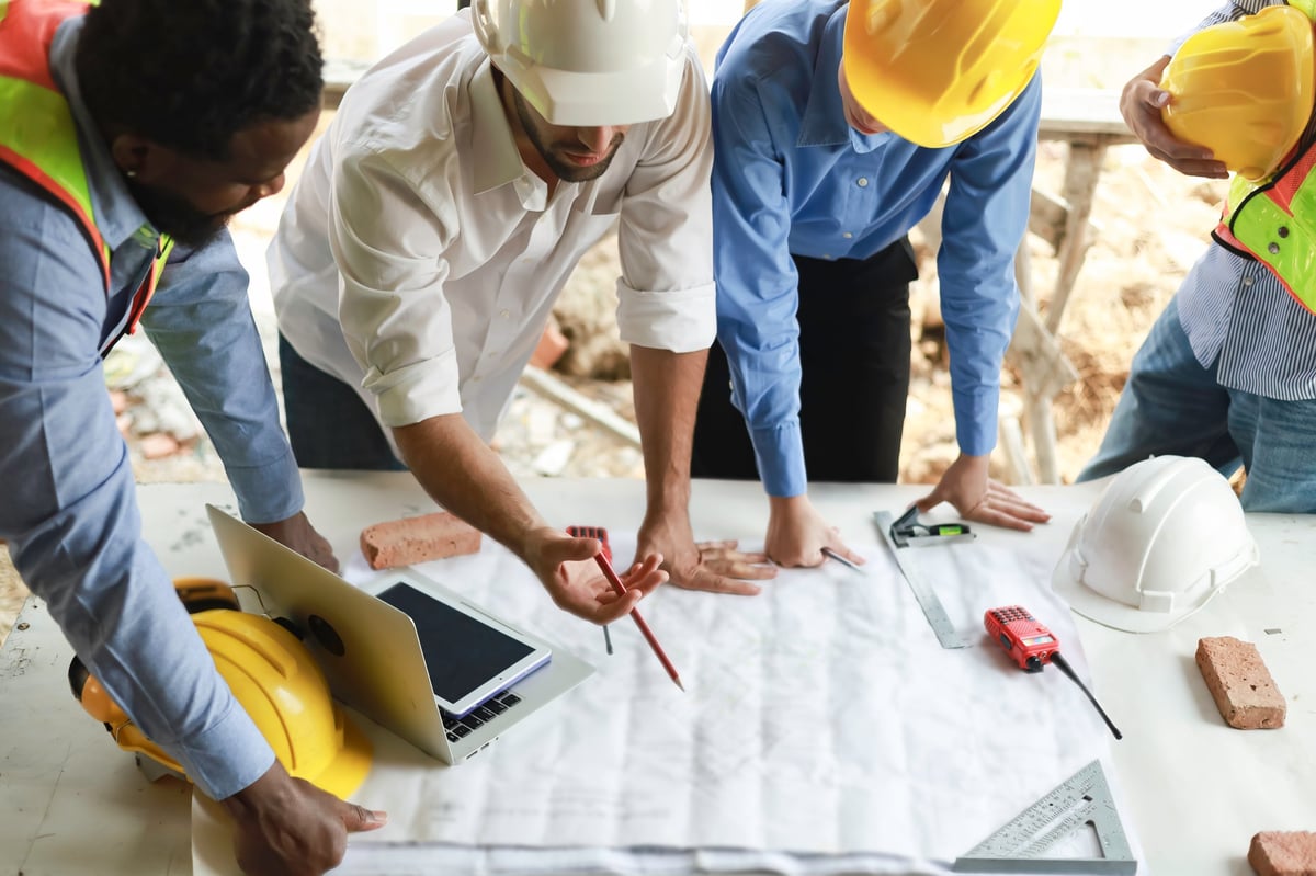 A group of African engineers and staff met to discuss and work together to assess the progress of a residential construction site